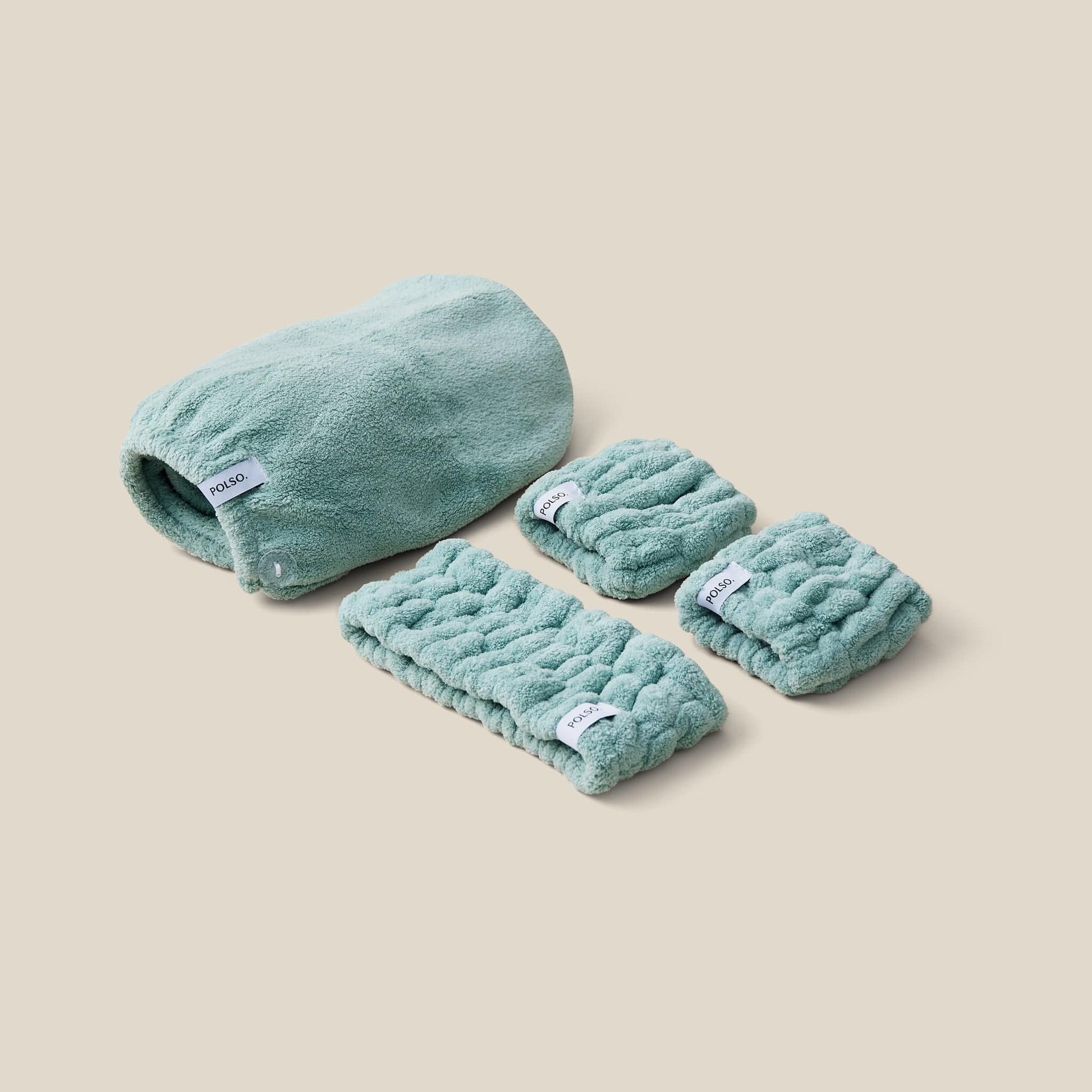 Flat lay image of the Sage Green set bundle including Wash Cuffs, Headband and Hair Turban