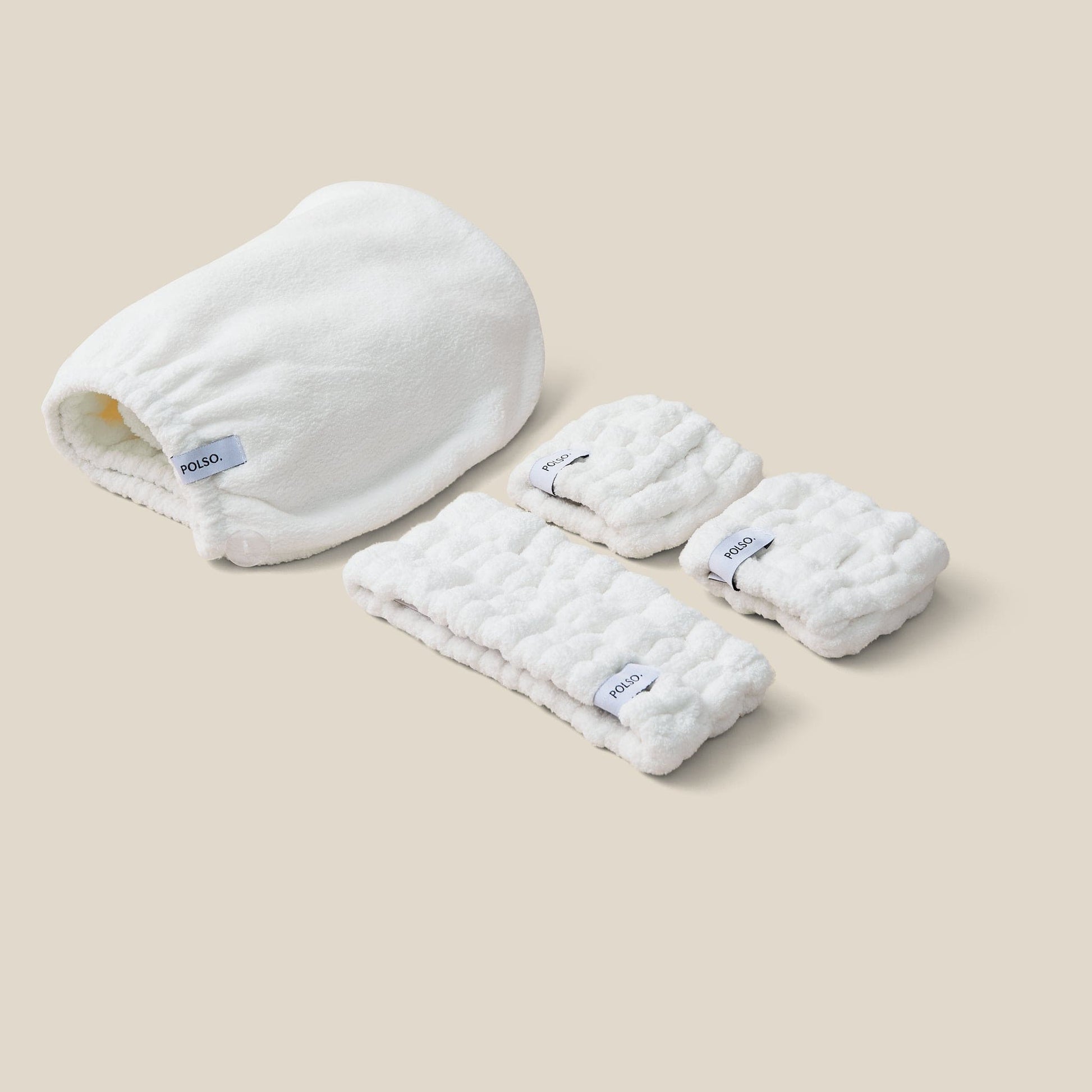 Flat lay image of the Spa white set bundle including Wash Cuffs, Headband and Hair Turban