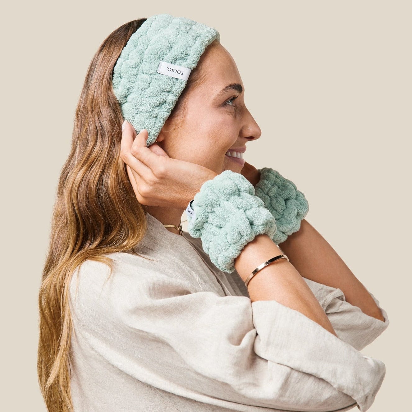Model wearing sage green wash cuffs and headband side perspective
