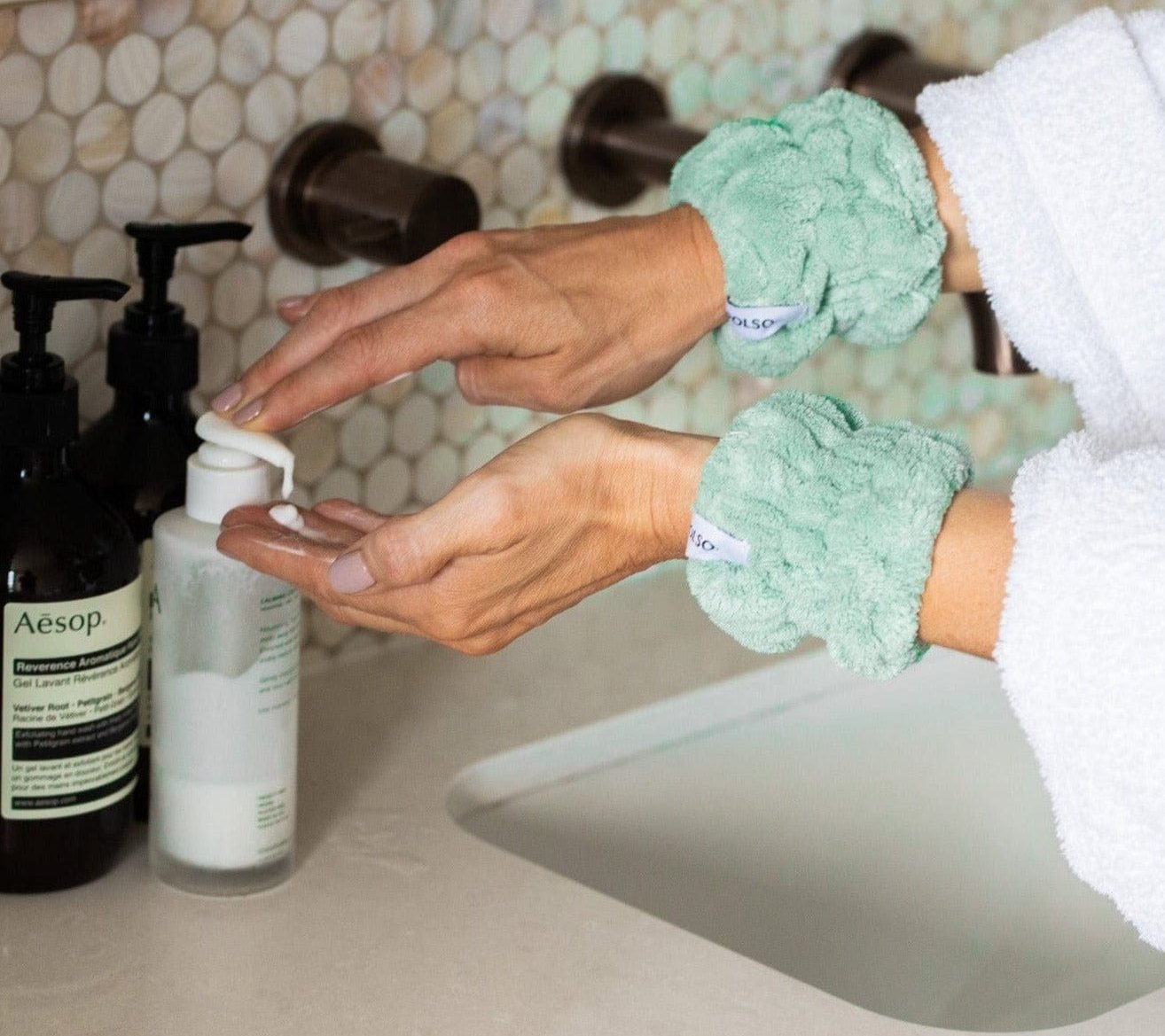 Sage Green Wash Cuffs on wrists washing face