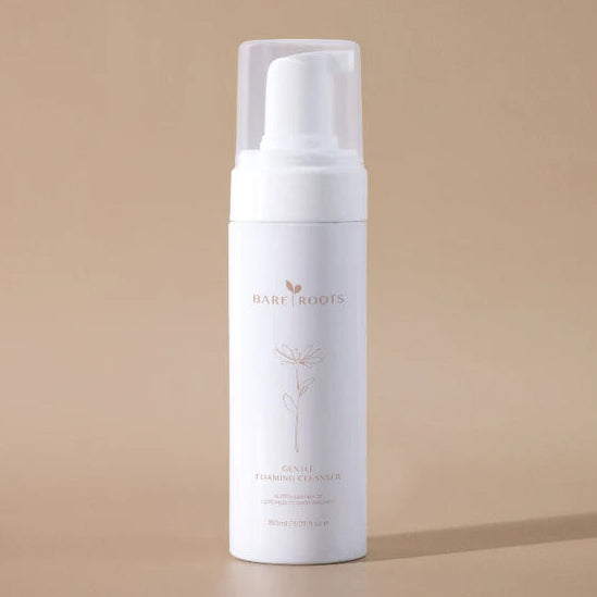 White foam bottle with 'Bare Roots' branding on a beige background