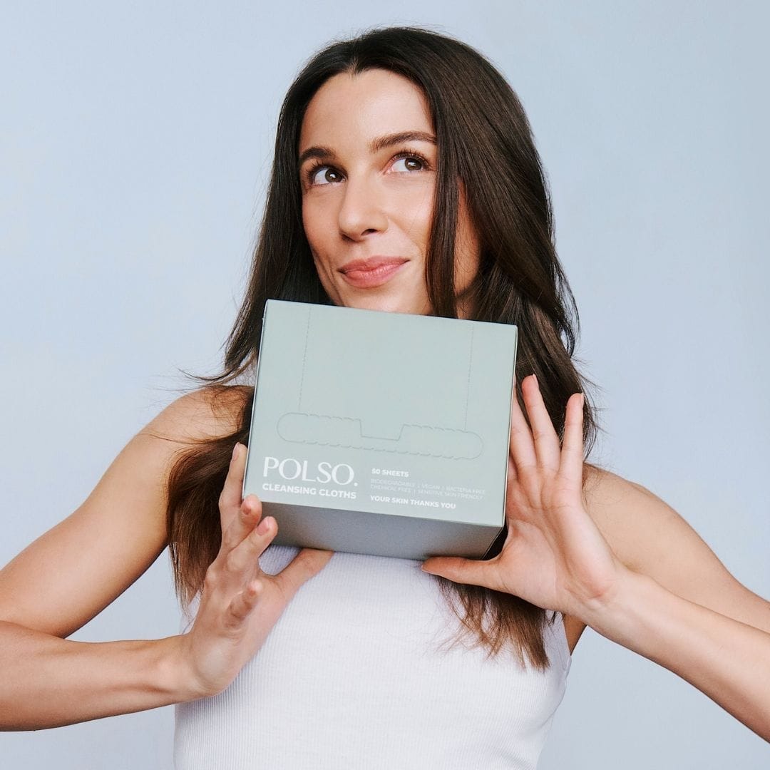 Woman holding a Polso product box against a light blue background