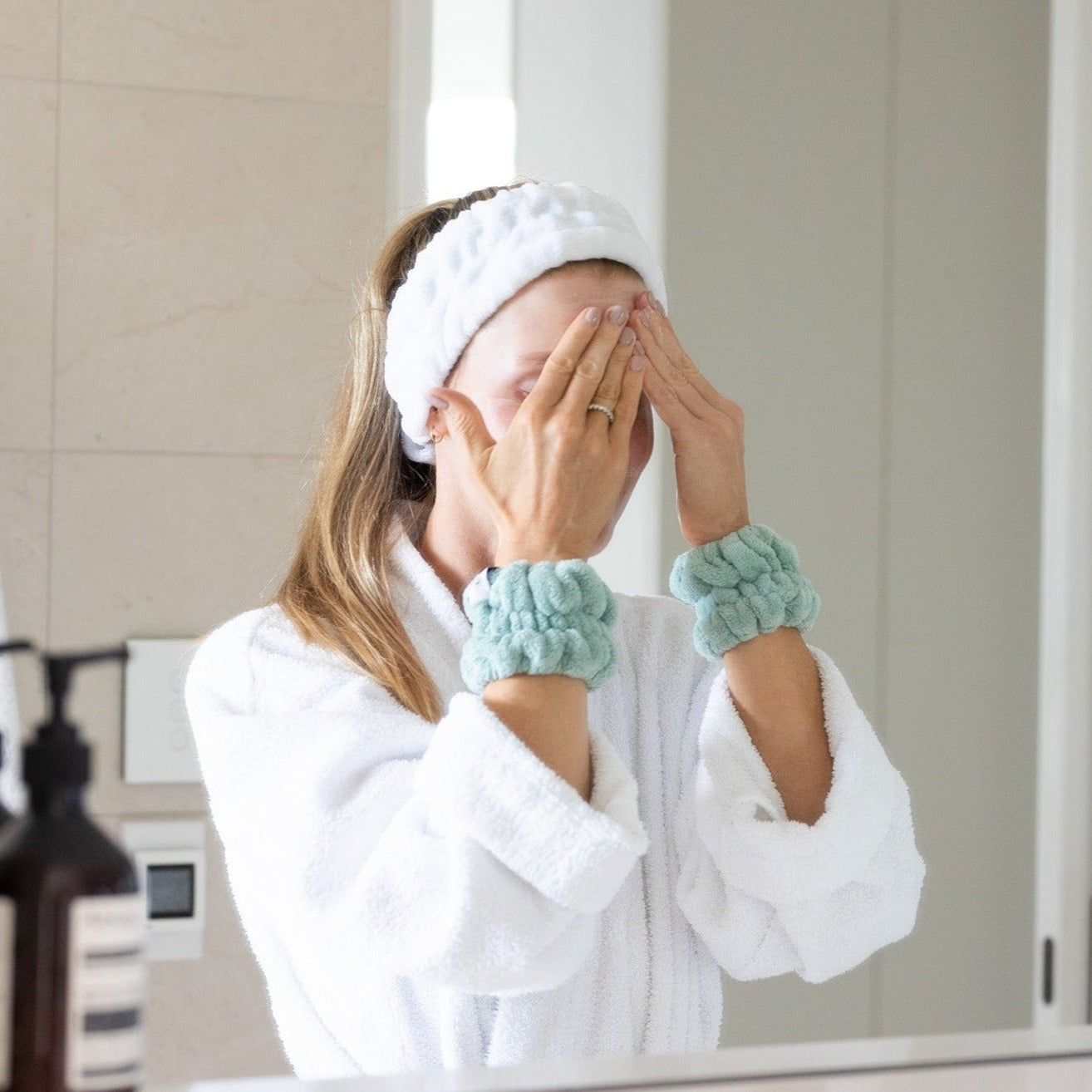 Sage Green Wash Cuffs on wrists washing face